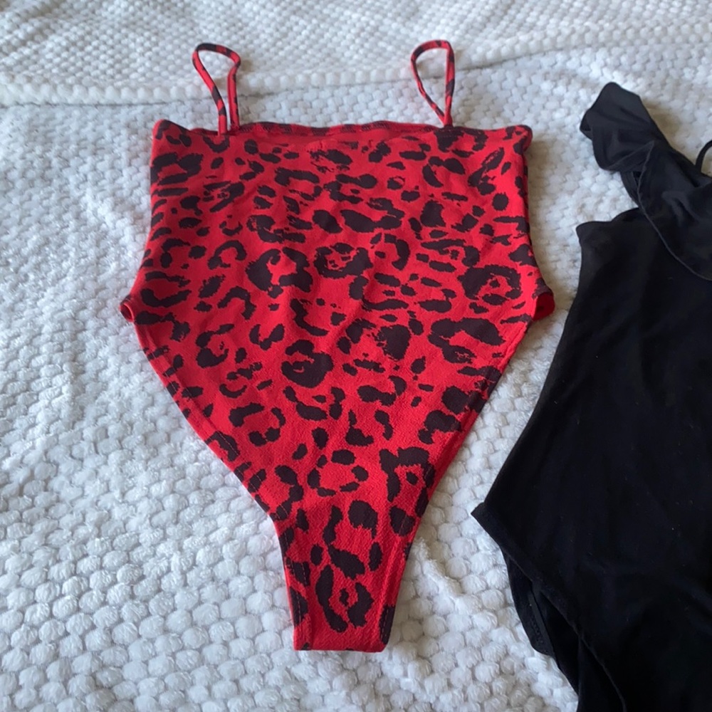 Bodysuits one red with prints. 2nd black.